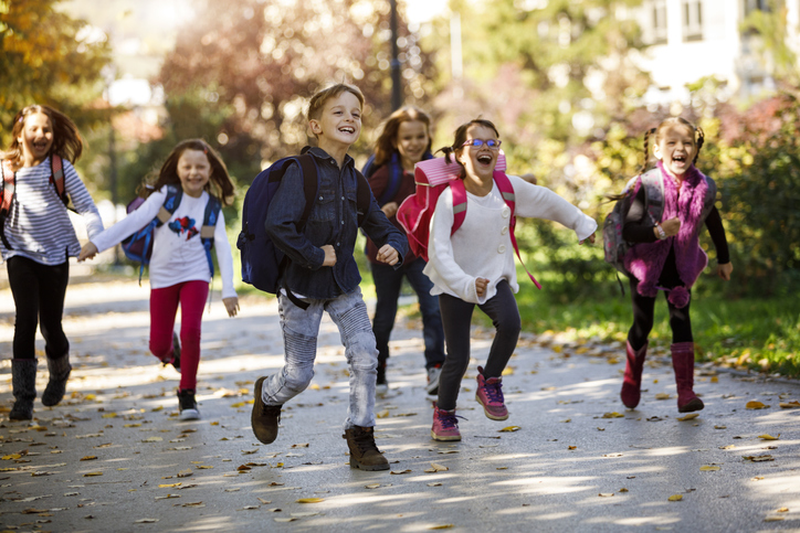 School kids running in schoolyard School kids running in schoolyard