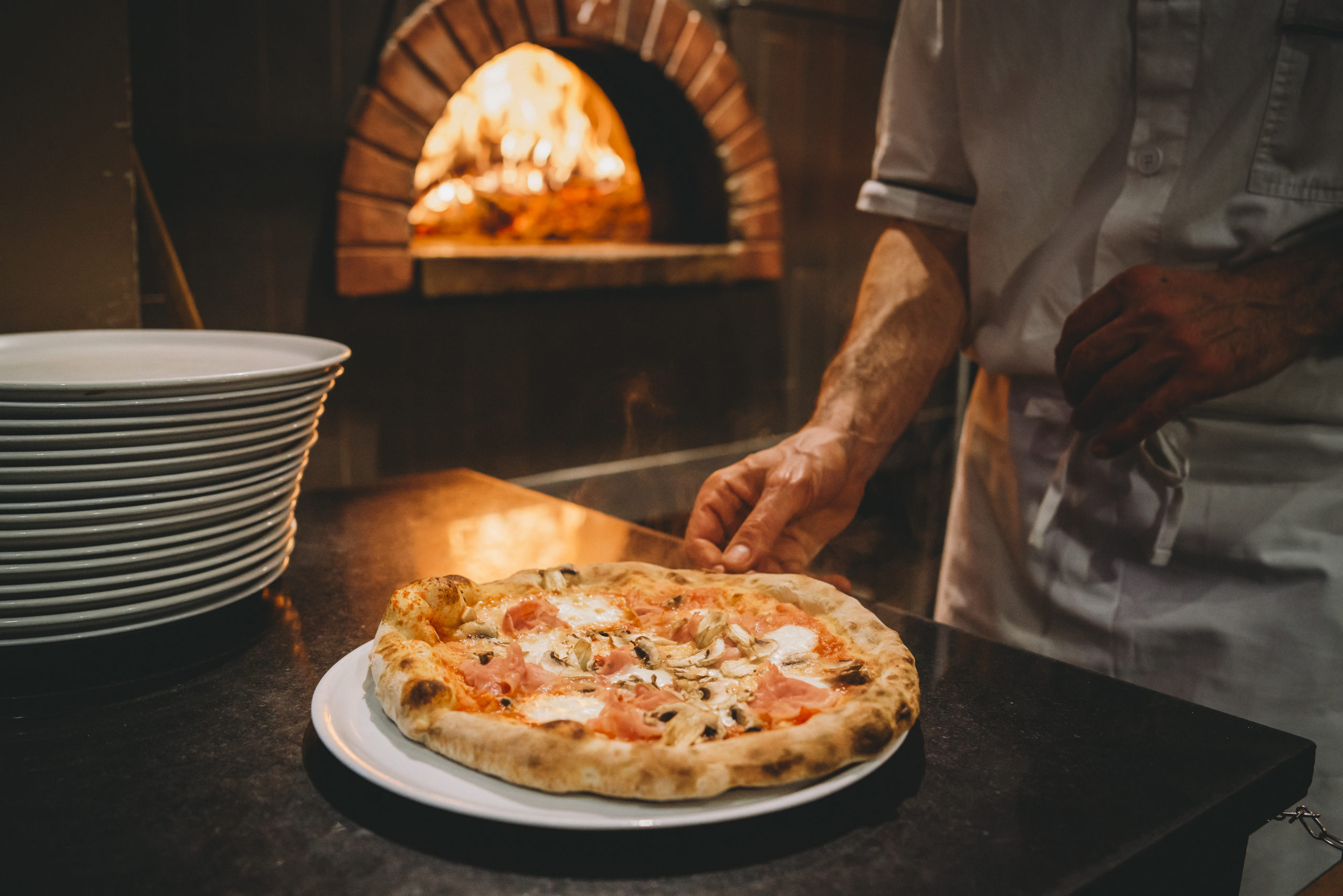 Pizza chef preparing pizza at the restaurant