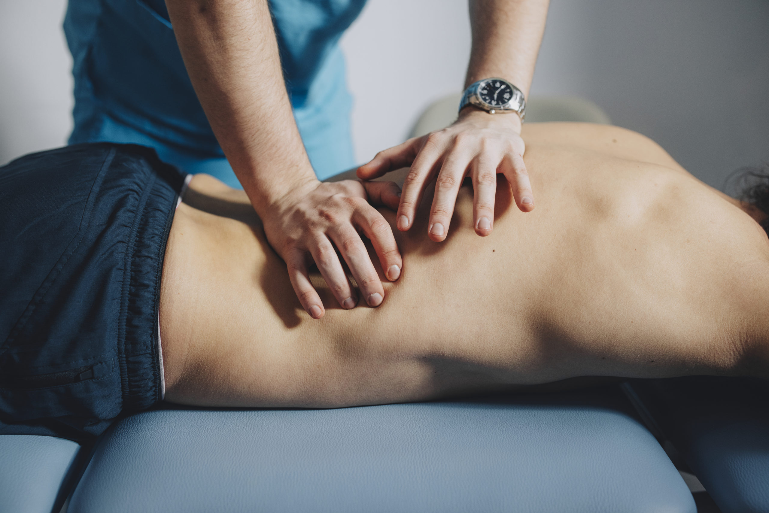 Close up of Physical Therapist Massaging Lower Back